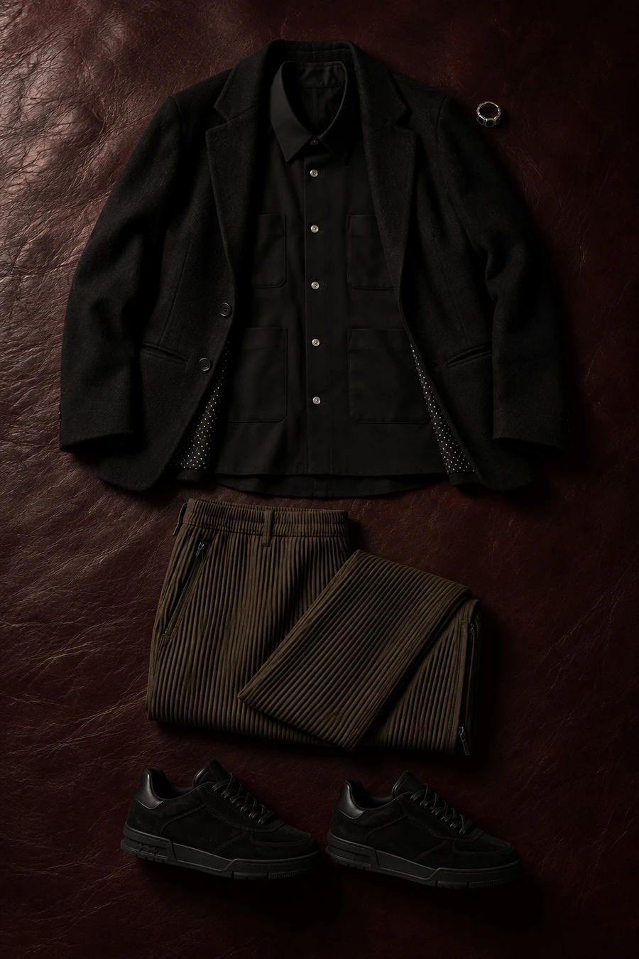 A black blazer for date night. Flat lay of a black Undercover blazer, a black UJOH shirt and dark brown Issey Miyake trousers.