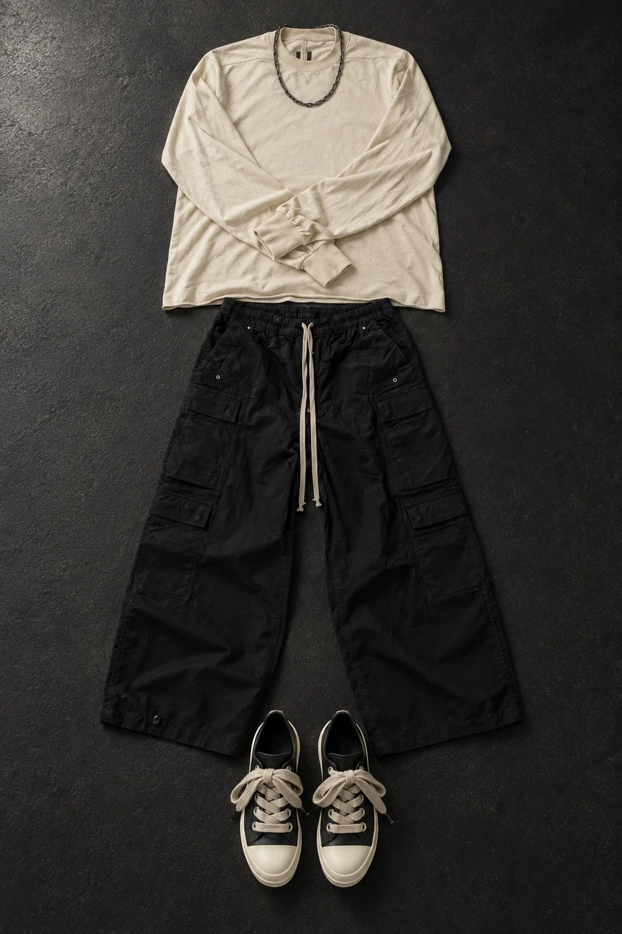 A concert, standing. Flat lay of a cream Rick Owens T-shirt, black cargo pants, black and milk sneakers and a Chrome Hearts necklace.