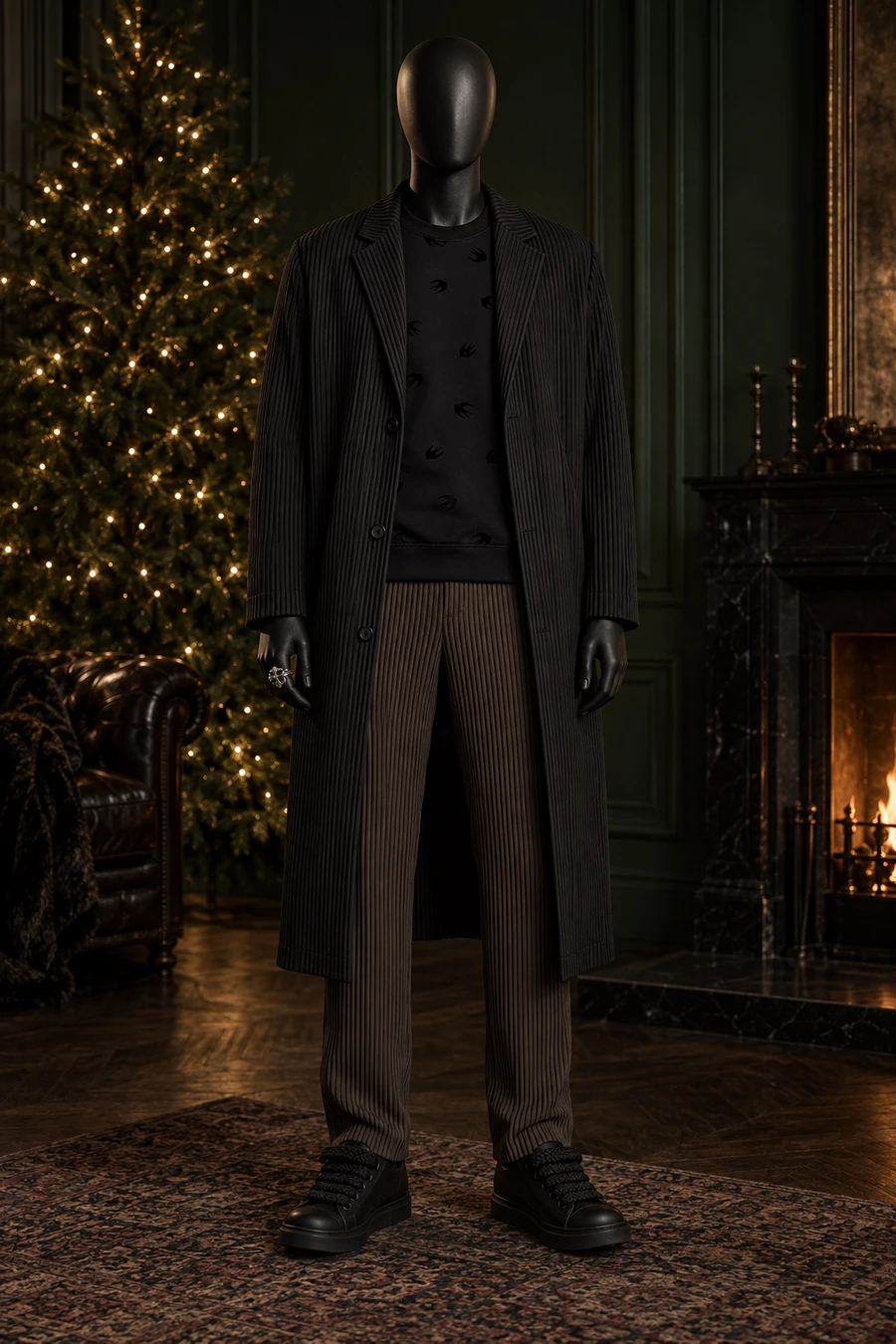 A faceless black mannequin wears a long Homme Plissé coat, an Alexander McQueen swallow sweatshirt, chocolate pleats and Rick Owens Temples by a lit fir tree.