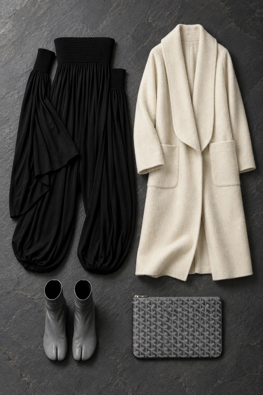 A winter wedding guest. Flat lay of a black Coperni dress, an ivory INTO THE EAST coat, grey MM6 ankle boots and a grey Goyard pouch.
