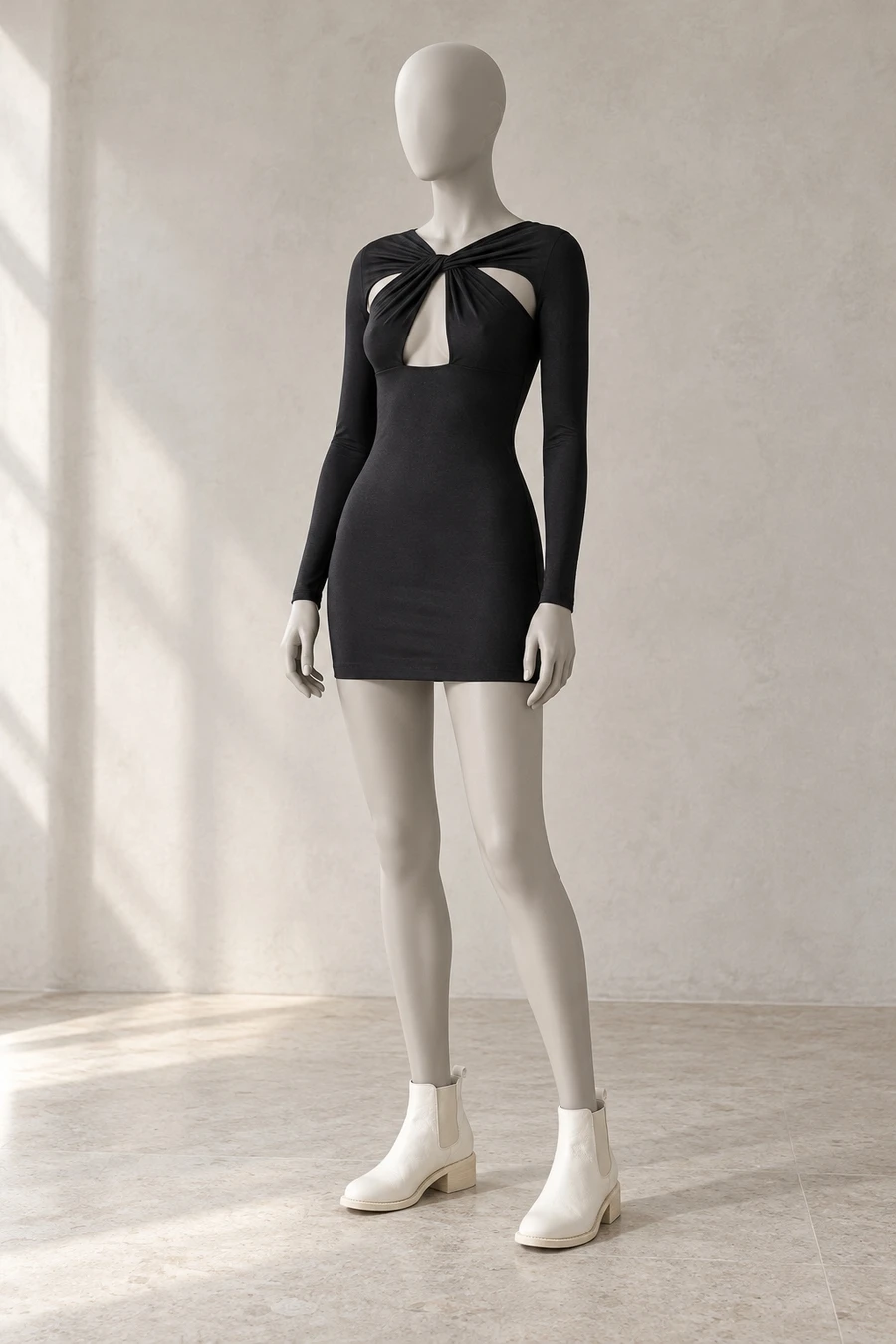 A faceless display mannequin in a Tokyo showroom. A black Coperni mini dress has a twisted neckline above white Guidi Chelsea boots.