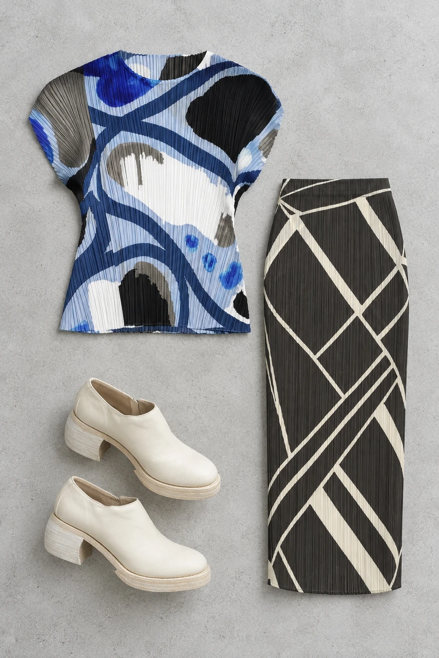 A blue Pleats Please top, black pleated skirt and white Guidi booties.