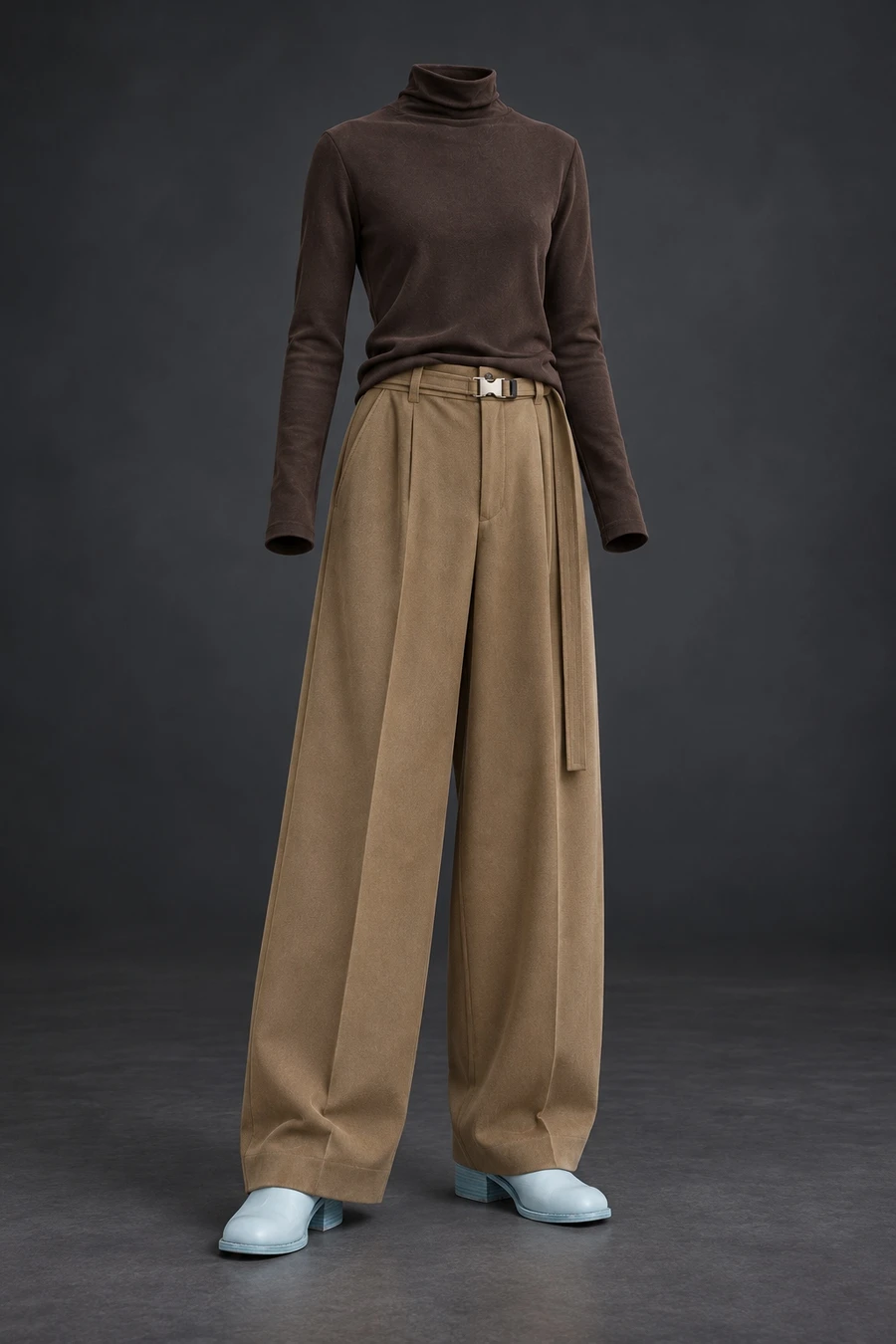 A dark brown RUOHAN knit meets wide UJOH trousers and pale aqua Guidi shoes. The complete outfit stands against a dark studio background.