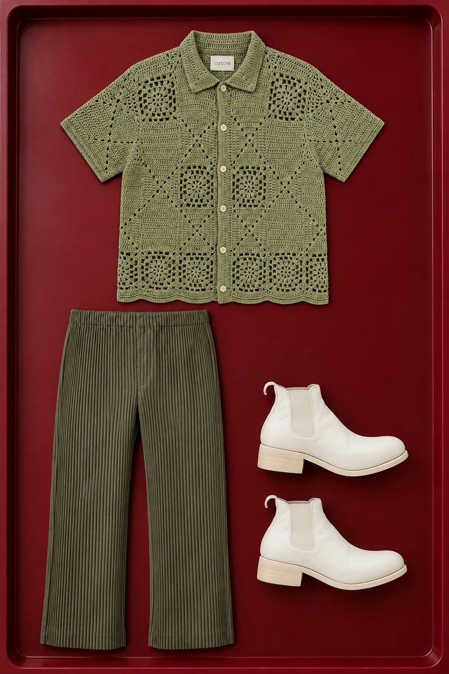A green Carbone crochet shirt, dark khaki pleated trousers and white Guidi boots.