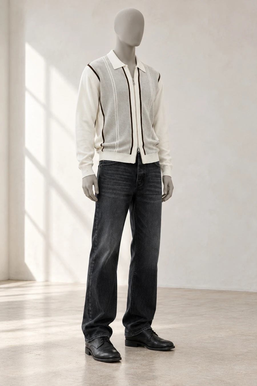 A faceless display mannequin in a London showroom. Brown stripes run down an ivory COOR knit above dark jeans and black Guidi derbies.