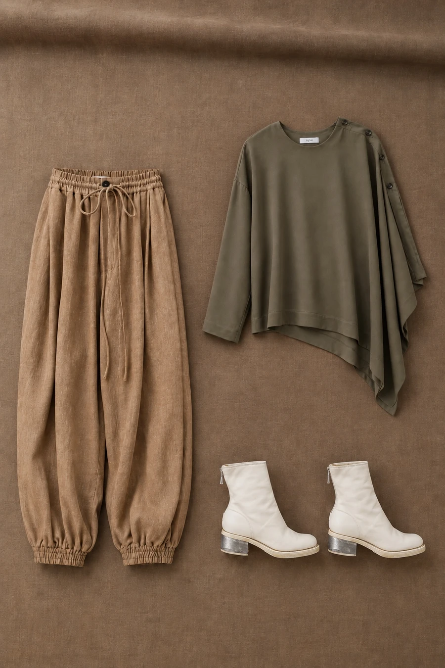 A moss UJOH blouse and light coffee trousers with white Guidi boots.