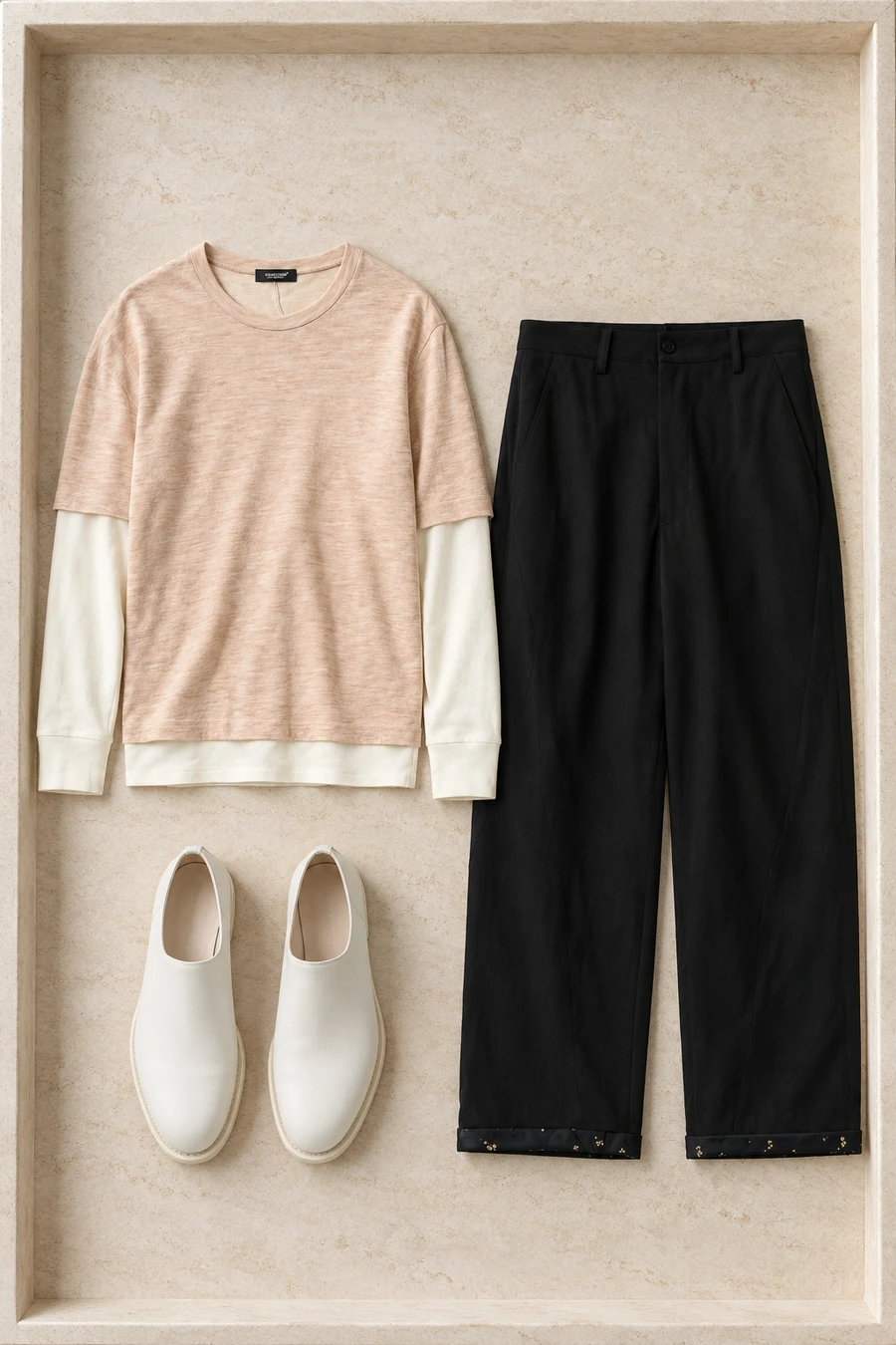 An Undercover pink layered tee and black relaxed trousers with white Guidi shoes.