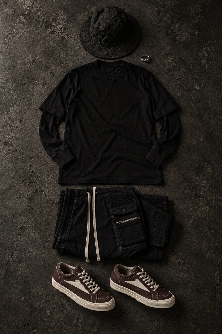 Rick Owens in black and oxblood. Flat lay of a black Rick Owens T-shirt, black cargo pants and deep oxblood sneakers.