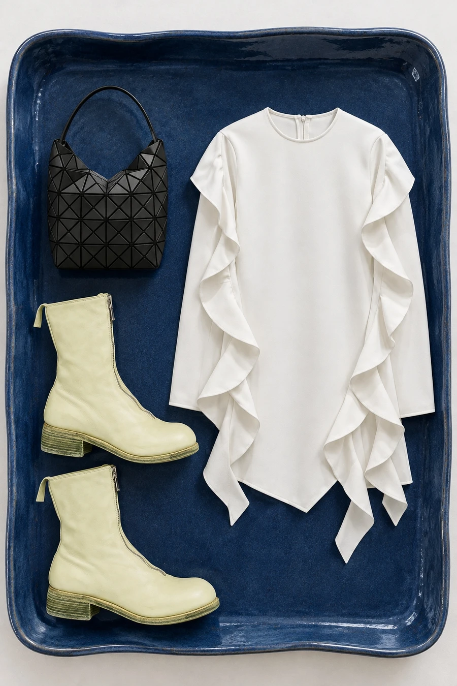 A white Ellery dress, pale kiwi Guidi boots and a black Bao Bao handbag.
