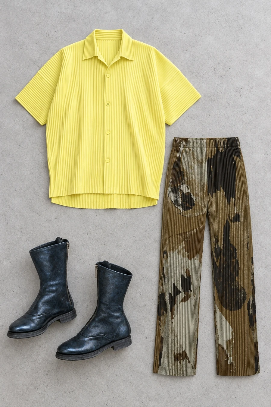 A yellow Homme Plisse shirt, brown trousers with a stone print and metallic blue Guidi boots.